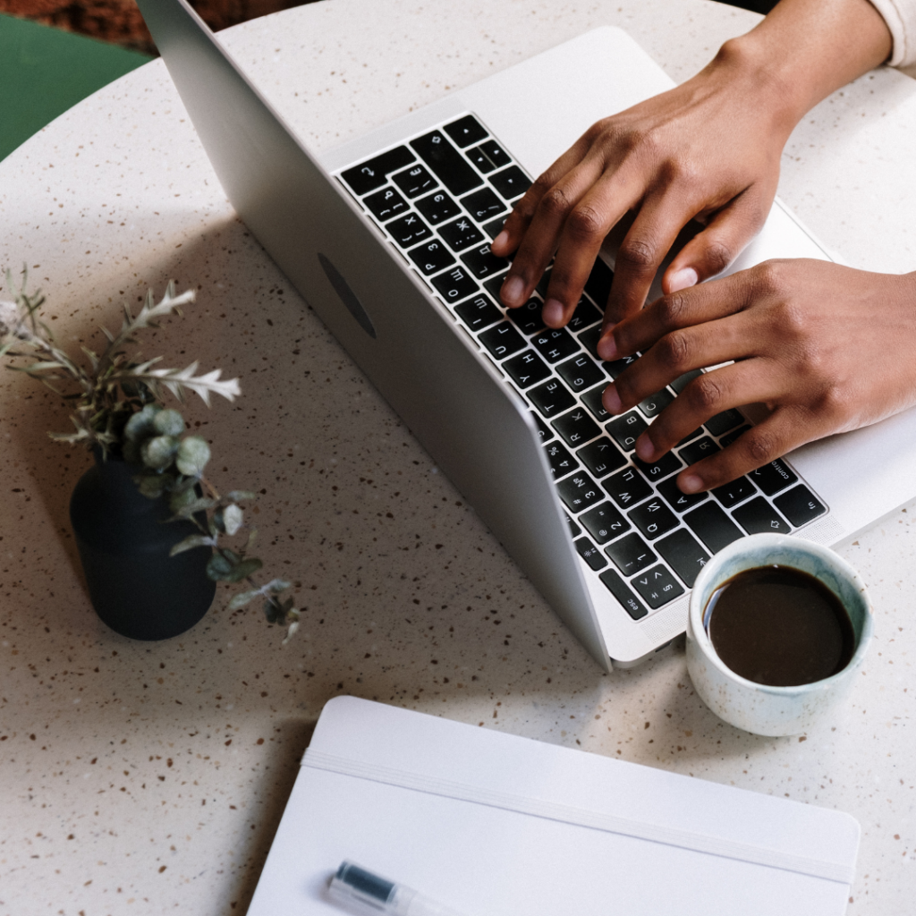 Person Writing a Blog Post on Laptop